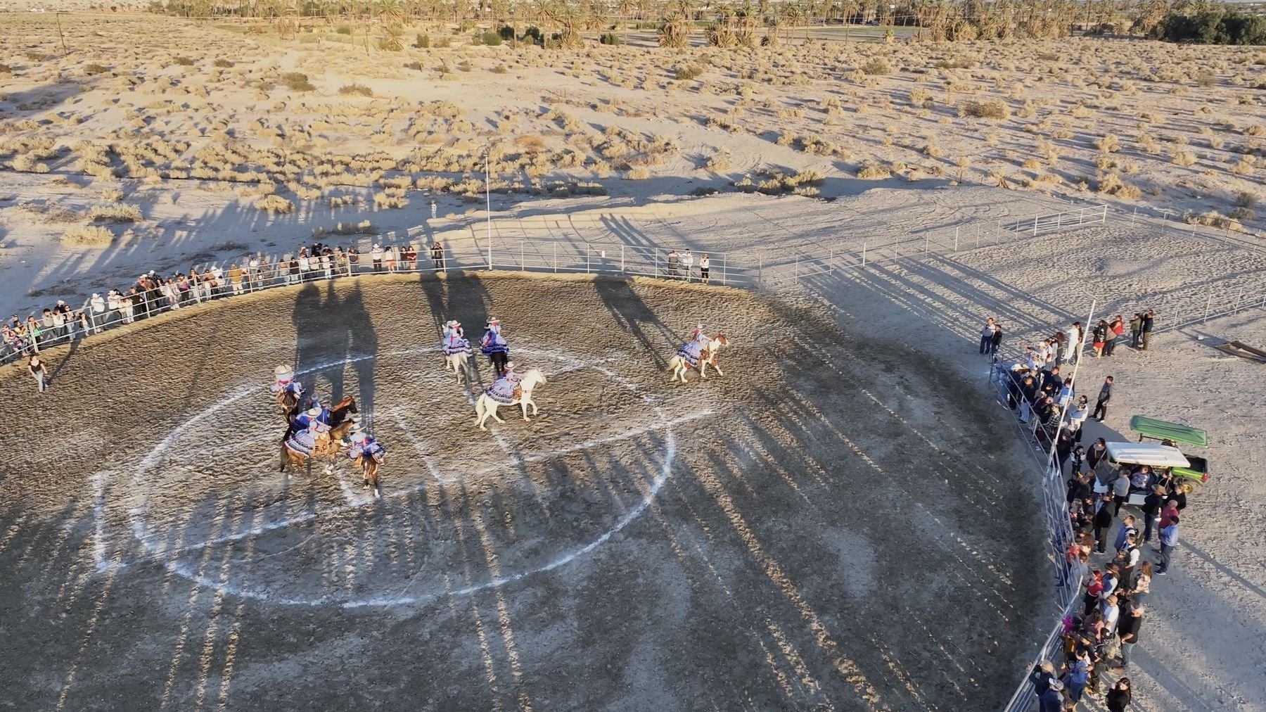 Aerial view of charreada riders performing in the lienzo charro at Rancho Escondido in Indio, California.
