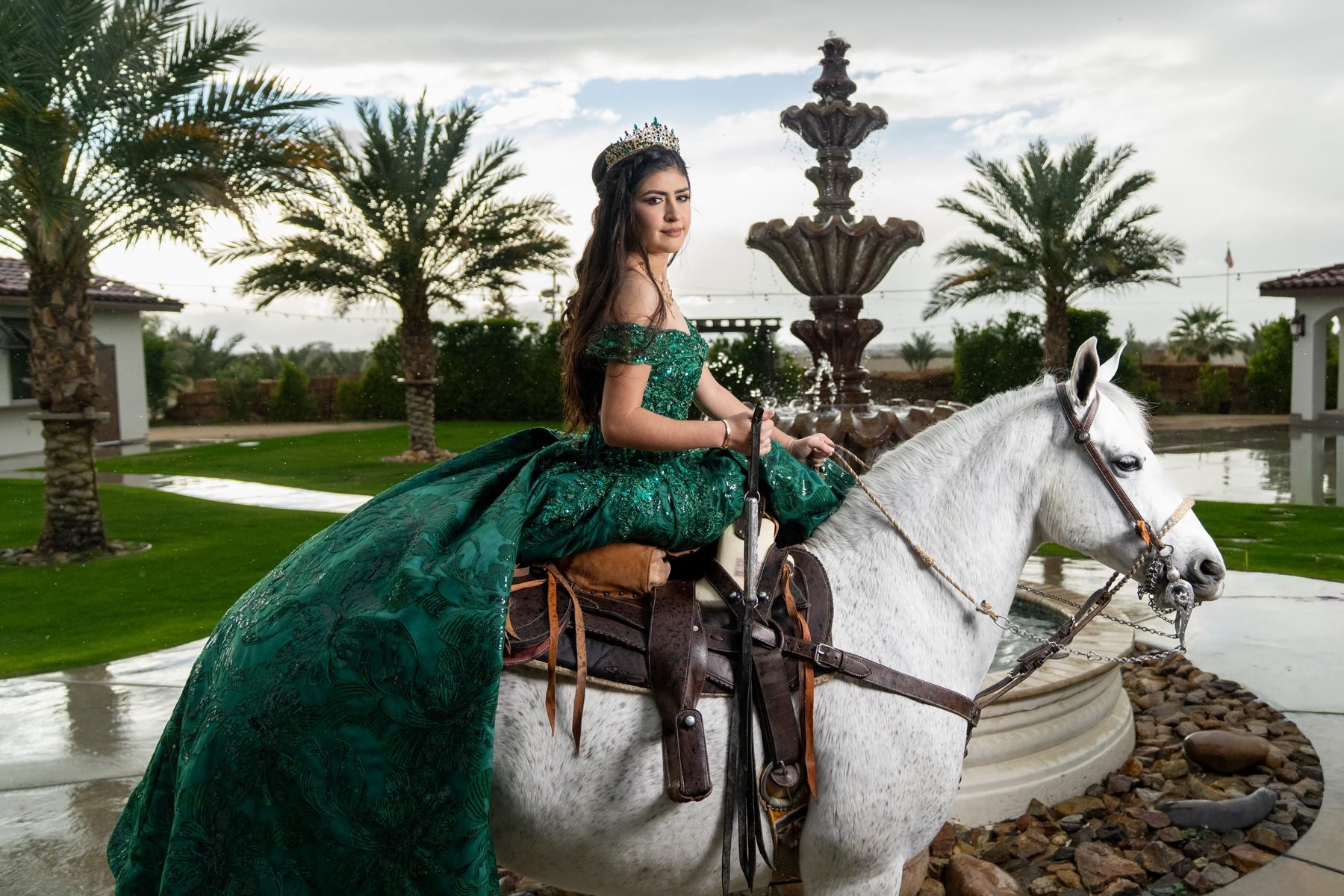 Quinceañera with a white horse beside the fountain at Rancho Escondido in Indio.