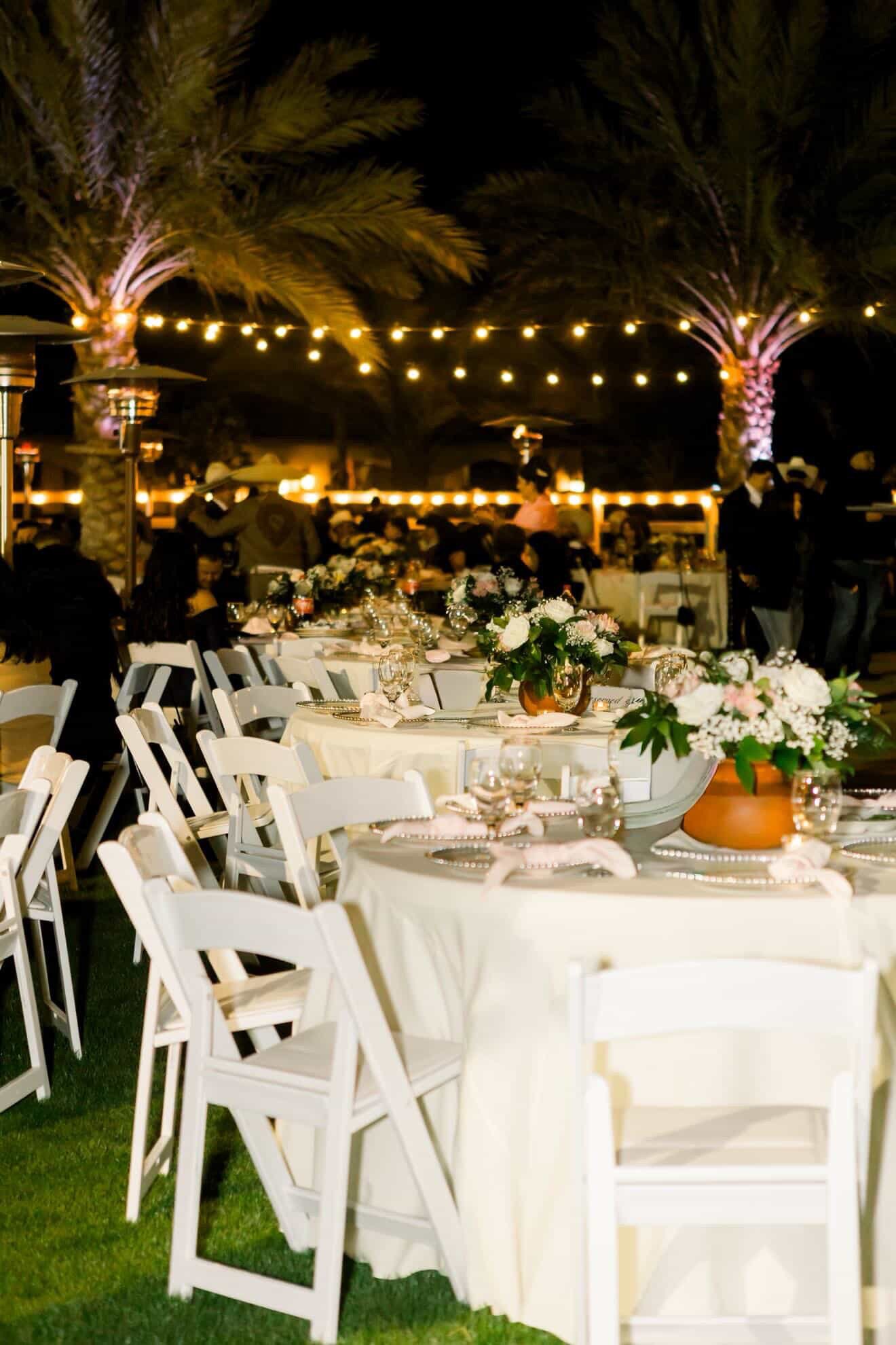 Wedding reception tablescape with terracotta centerpieces and white linens at Rancho Escondido in Indio.